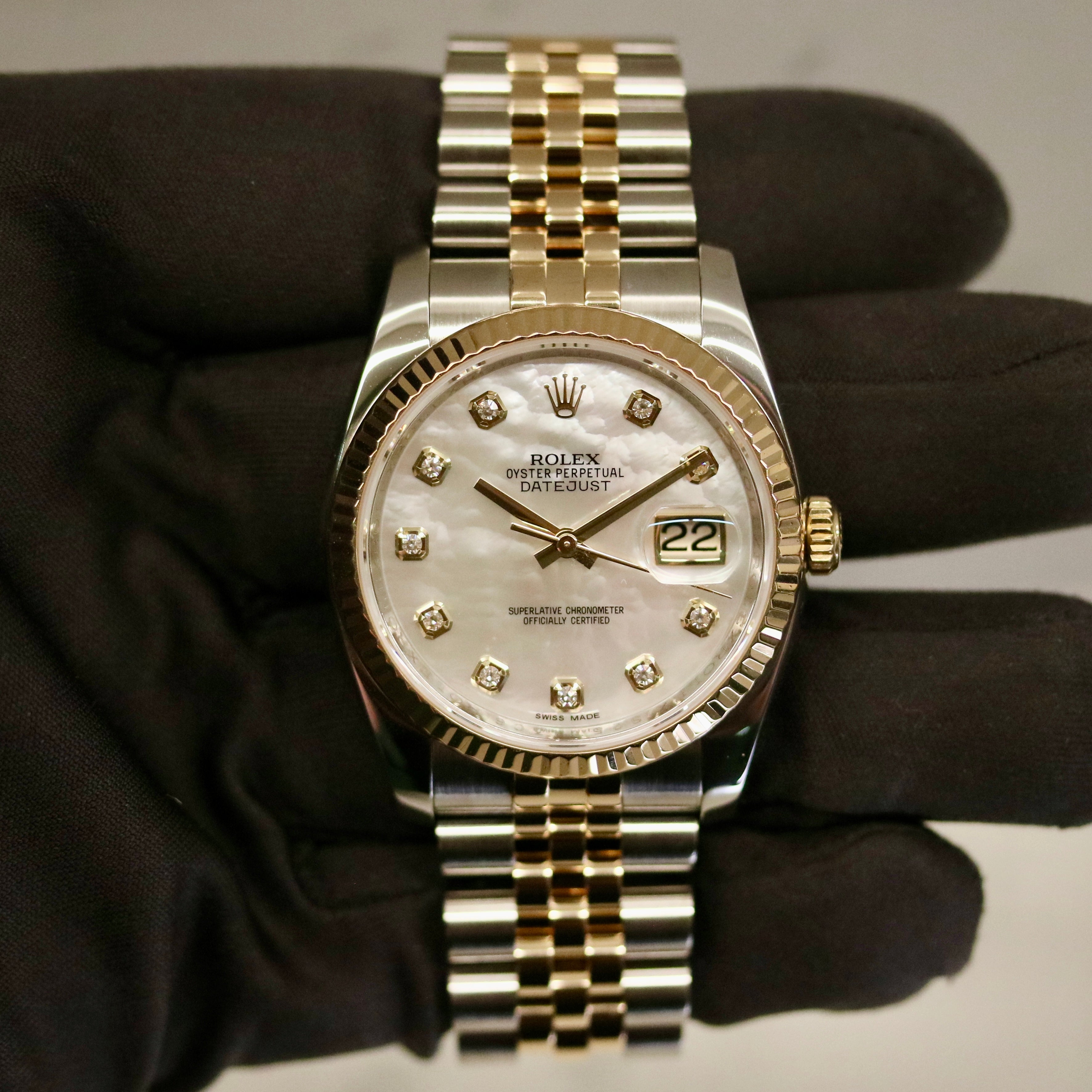Rolex Datejust 36 ref. 116233 from 2013 in steel and yellow gold with a factory white mother-of-pearl diamond dial, 36mm case, Jubilee bracelet, sapphire crystal, and automatic movement. Detailed product photos showing the dial texture, diamond markers, two-tone case and bracelet, fluted bezel, and overall condition. Includes original Swedish papers from Nymans Ur, original receipt, 2020 service card, box, and tags, offered by Klocksalongen with a 12-month functional warranty.