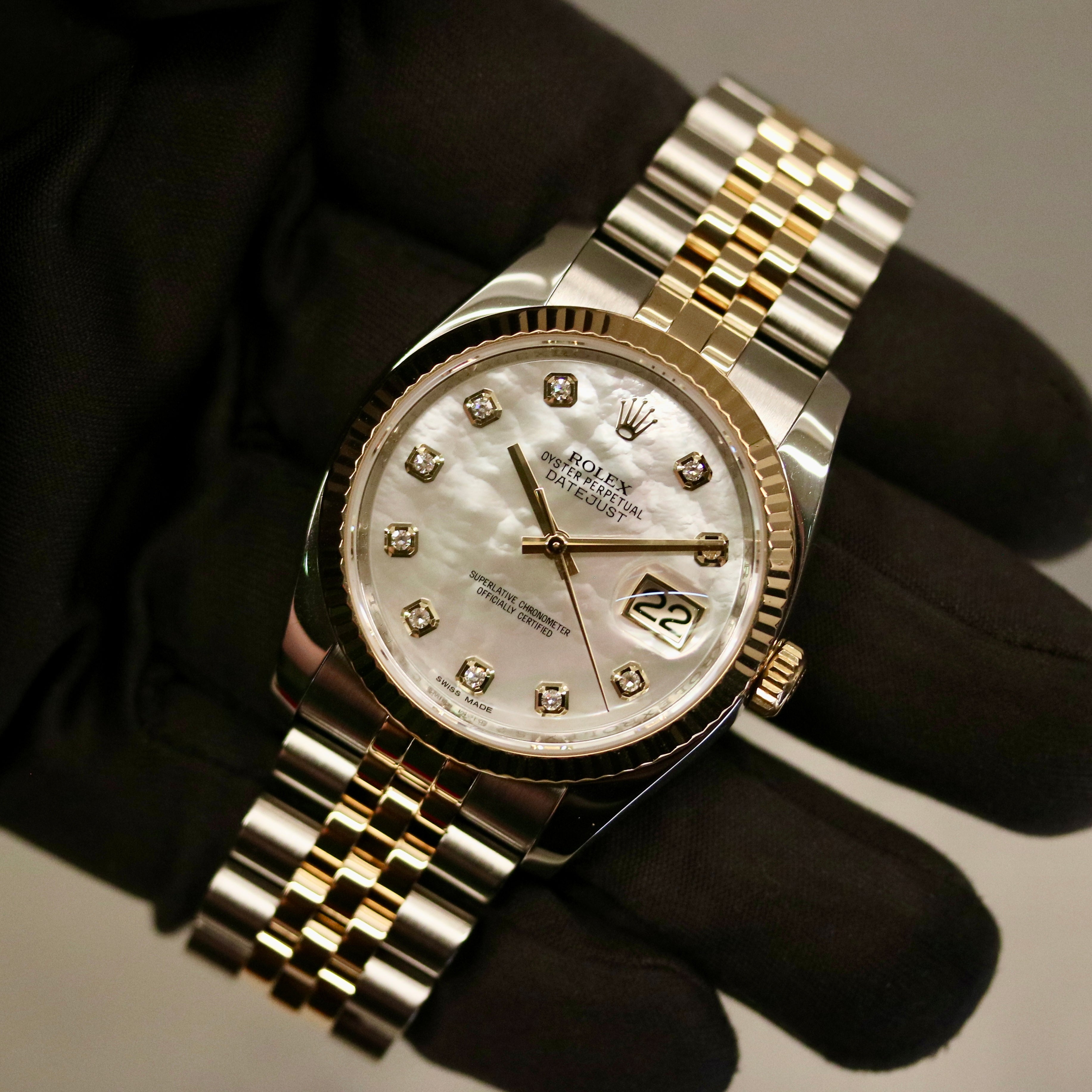 Rolex Datejust 36 ref. 116233 from 2013 in steel and yellow gold with a factory white mother-of-pearl diamond dial, 36mm case, Jubilee bracelet, sapphire crystal, and automatic movement. Detailed product photos showing the dial texture, diamond markers, two-tone case and bracelet, fluted bezel, and overall condition. Includes original Swedish papers from Nymans Ur, original receipt, 2020 service card, box, and tags, offered by Klocksalongen with a 12-month functional warranty.