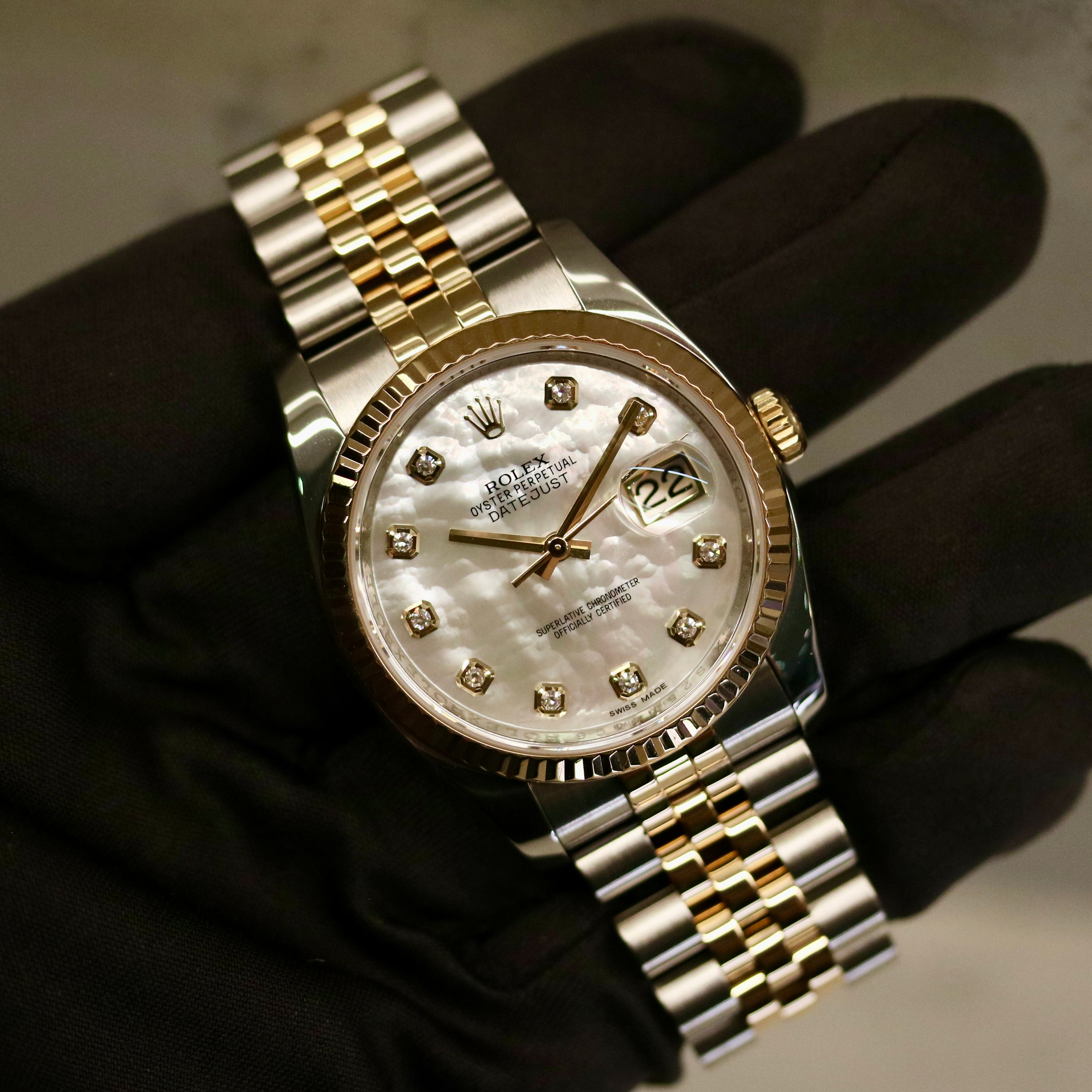 Rolex Datejust 36 ref. 116233 from 2013 in steel and yellow gold with a factory white mother-of-pearl diamond dial, 36mm case, Jubilee bracelet, sapphire crystal, and automatic movement. Detailed product photos showing the dial texture, diamond markers, two-tone case and bracelet, fluted bezel, and overall condition. Includes original Swedish papers from Nymans Ur, original receipt, 2020 service card, box, and tags, offered by Klocksalongen with a 12-month functional warranty.