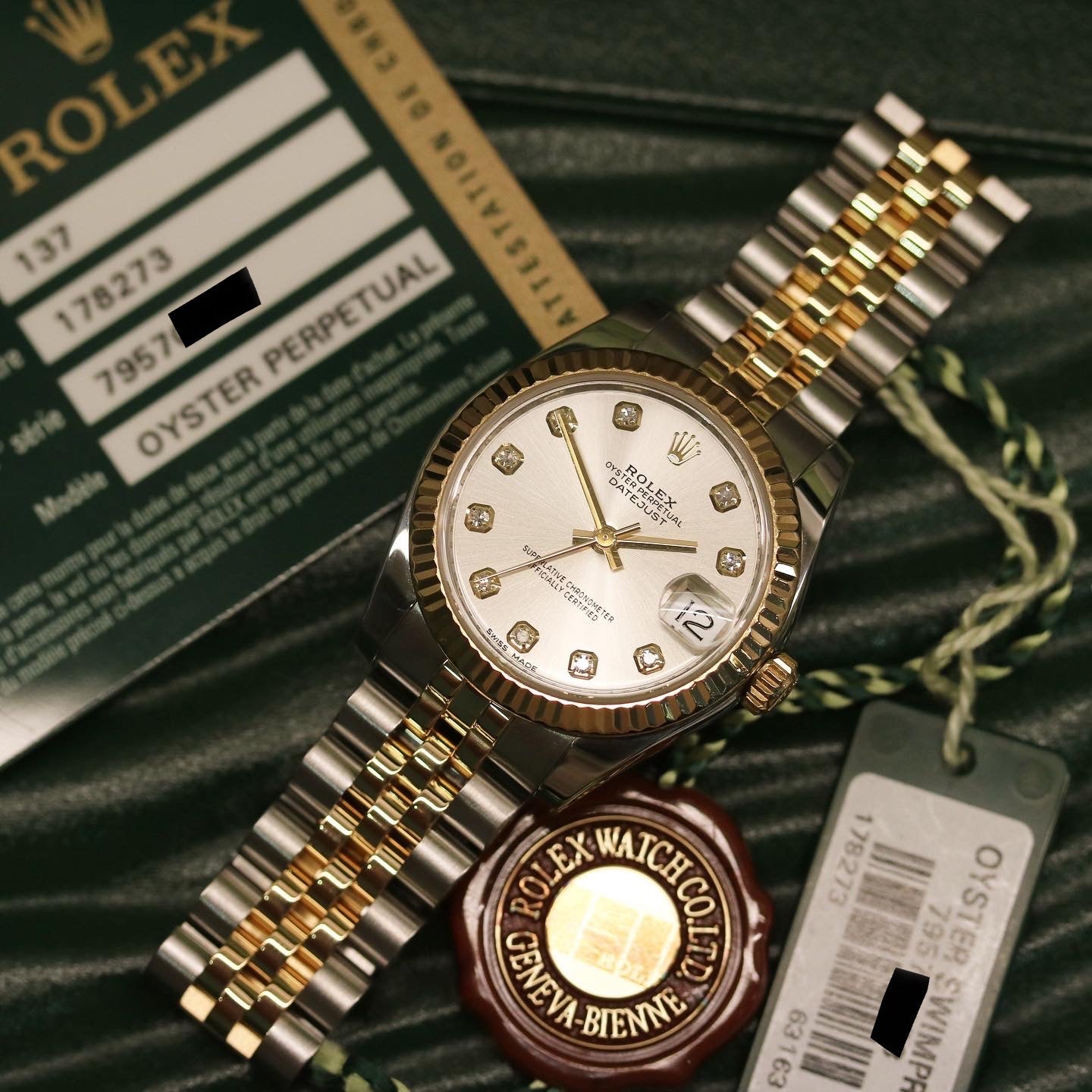 Rolex Datejust 31 ref. 178273 from 2012 in two-tone stainless steel and yellow gold with a factory silver diamond dial, 31mm case, Jubilee bracelet, sapphire crystal, and automatic movement. Presented in very good condition with original 2012 Netherlands certificate, box, tags, certificate holder, and booklets. Detailed product photos show the diamond markers, fluted bezel, case, bracelet, and clasp, offered by Klocksalongen with a 12-month functional warranty.