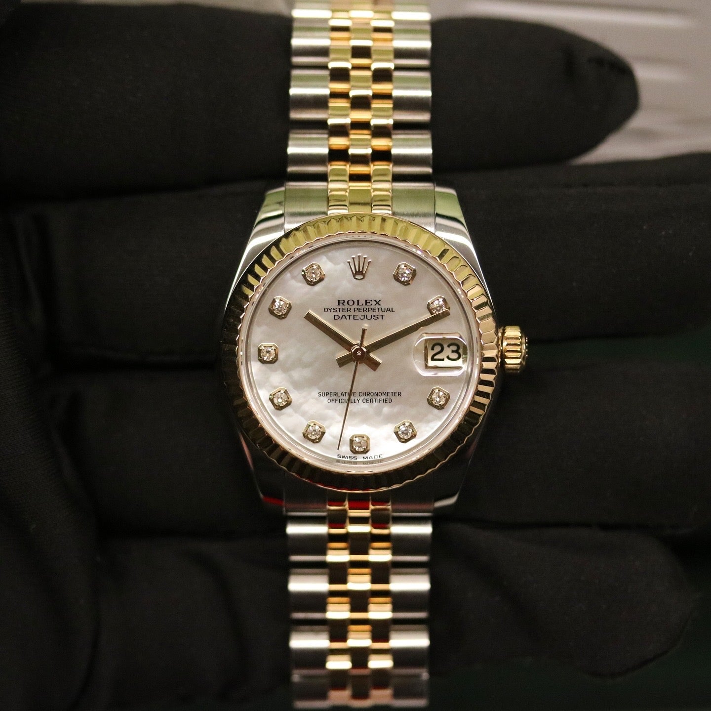 Rolex Datejust 31 ref. 178273 from 2017 in two-tone stainless steel and yellow gold with a factory white mother-of-pearl diamond dial, 31mm case, Jubilee bracelet, sapphire crystal, and automatic movement. Very good condition, complete with original 2017 Bergströms Uppsala certificate, box, booklets, and tag. Detailed product images showing the MOP dial texture, diamond markers, fluted bezel, case, bracelet, and clasp, offered by Klocksalongen with a 12-month functional warranty.