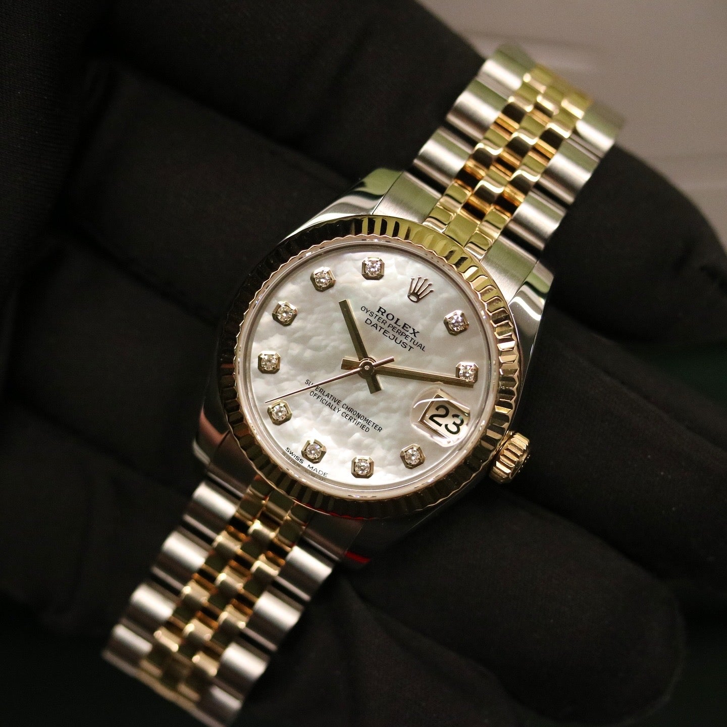 Rolex Datejust 31 ref. 178273 from 2017 in two-tone stainless steel and yellow gold with a factory white mother-of-pearl diamond dial, 31mm case, Jubilee bracelet, sapphire crystal, and automatic movement. Very good condition, complete with original 2017 Bergströms Uppsala certificate, box, booklets, and tag. Detailed product images showing the MOP dial texture, diamond markers, fluted bezel, case, bracelet, and clasp, offered by Klocksalongen with a 12-month functional warranty.