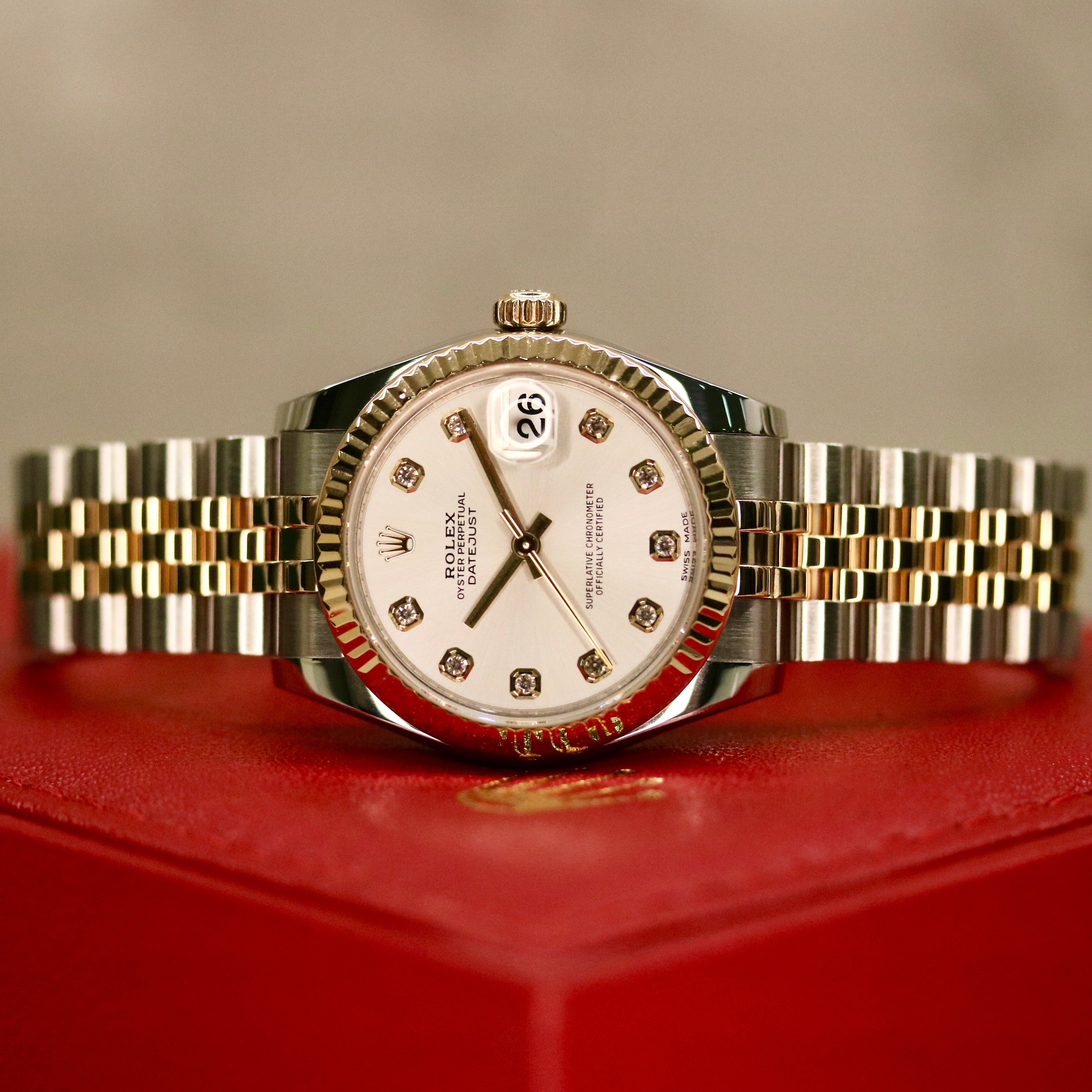 Rolex Datejust 31 ref. 178273 from 2018 in two-tone stainless steel and yellow gold with a factory silver diamond dial, 31mm case, Jubilee bracelet, sapphire crystal, and automatic movement. Presented in very good condition with original Egypt 2018 certificate, box, booklets, and tags. Includes photos detailing the diamond dial, fluted bezel, bracelet, case, and clasp, offered by Klocksalongen with a 12-month functional warranty.