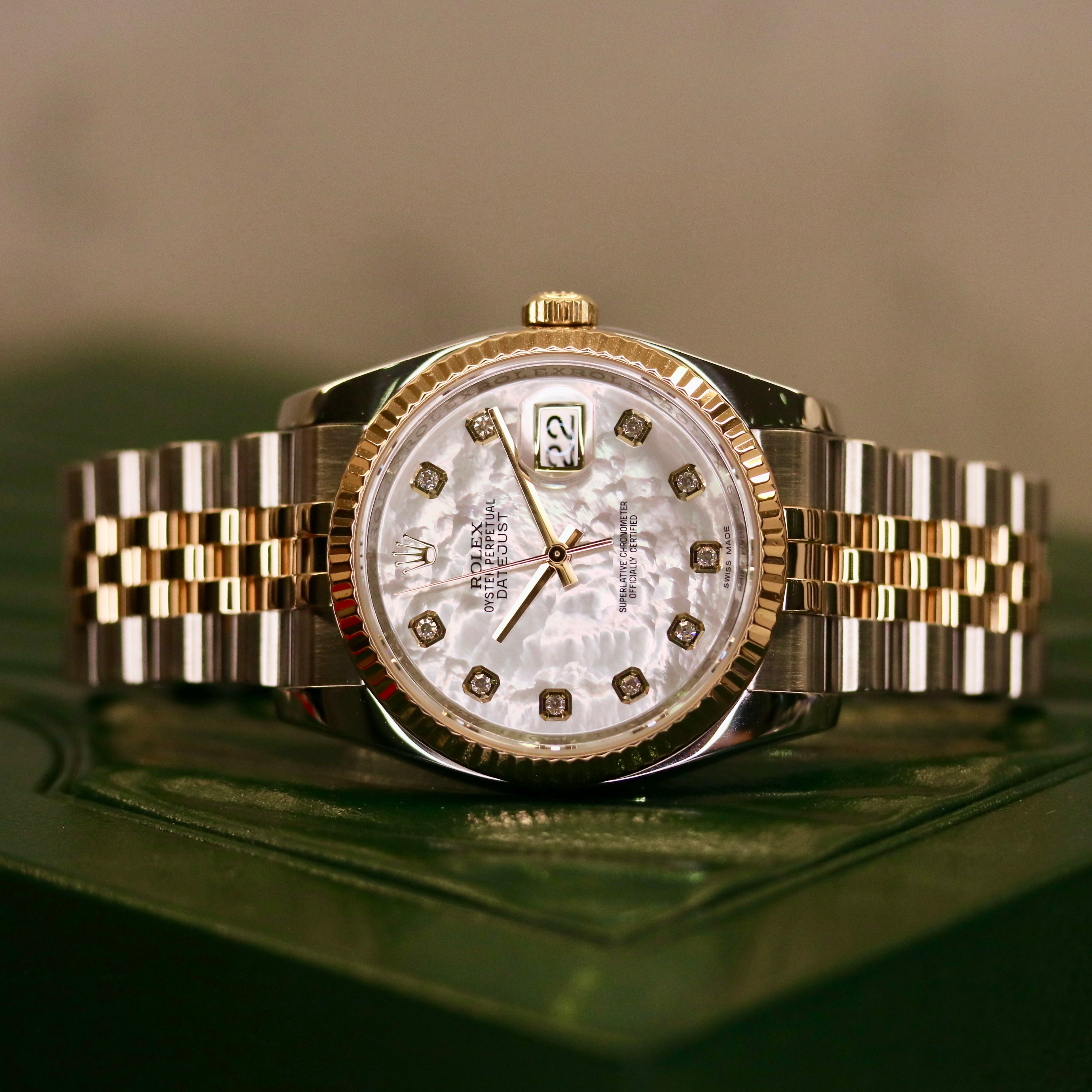 Rolex Datejust 36 ref. 116233 from 2013 in steel and yellow gold with a factory white mother-of-pearl diamond dial, 36mm case, Jubilee bracelet, sapphire crystal, and automatic movement. Detailed product photos showing the dial texture, diamond markers, two-tone case and bracelet, fluted bezel, and overall condition. Includes original Swedish papers from Nymans Ur, original receipt, 2020 service card, box, and tags, offered by Klocksalongen with a 12-month functional warranty.
