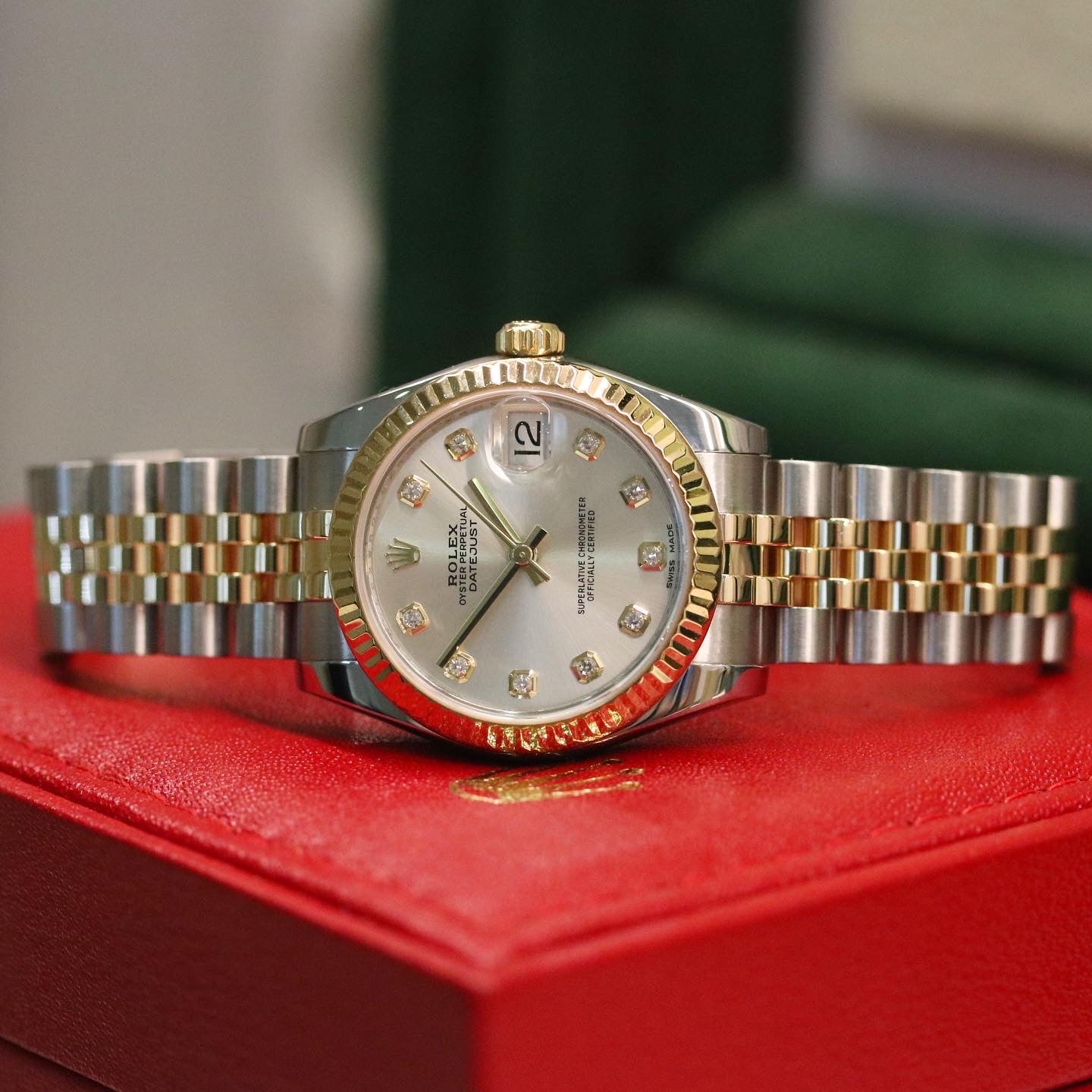 Rolex Datejust 31 ref. 178273 from 2012 in two-tone stainless steel and yellow gold with a factory silver diamond dial, 31mm case, Jubilee bracelet, sapphire crystal, and automatic movement. Presented in very good condition with original 2012 Netherlands certificate, box, tags, certificate holder, and booklets. Detailed product photos show the diamond markers, fluted bezel, case, bracelet, and clasp, offered by Klocksalongen with a 12-month functional warranty.