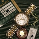 Rolex Datejust 31 ref. 178273 from 2012 in two-tone stainless steel and yellow gold with a factory silver diamond dial, 31mm case, Jubilee bracelet, sapphire crystal, and automatic movement. Presented in very good condition with original 2012 Netherlands certificate, box, tags, certificate holder, and booklets. Detailed product photos show the diamond markers, fluted bezel, case, bracelet, and clasp, offered by Klocksalongen with a 12-month functional warranty.