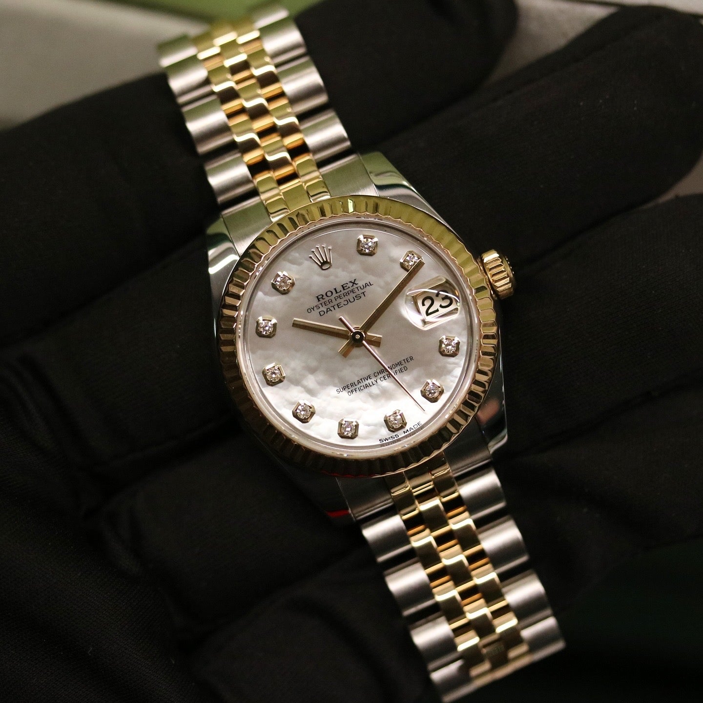 Rolex Datejust 31 ref. 178273 from 2017 in two-tone stainless steel and yellow gold with a factory white mother-of-pearl diamond dial, 31mm case, Jubilee bracelet, sapphire crystal, and automatic movement. Very good condition, complete with original 2017 Bergströms Uppsala certificate, box, booklets, and tag. Detailed product images showing the MOP dial texture, diamond markers, fluted bezel, case, bracelet, and clasp, offered by Klocksalongen with a 12-month functional warranty.