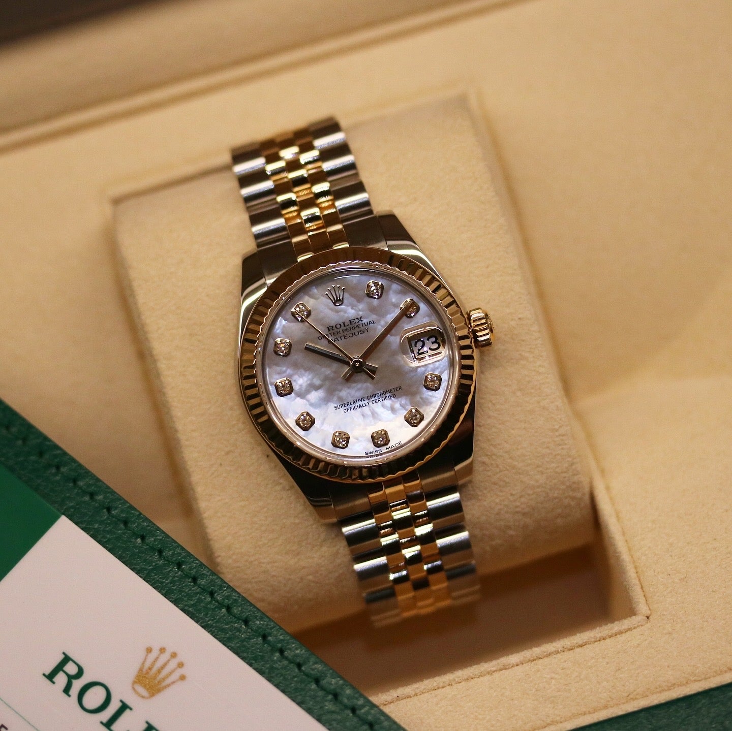 Rolex Datejust 31 ref. 178273 from 2017 in two-tone stainless steel and yellow gold with a factory white mother-of-pearl diamond dial, 31mm case, Jubilee bracelet, sapphire crystal, and automatic movement. Very good condition, complete with original 2017 Bergströms Uppsala certificate, box, booklets, and tag. Detailed product images showing the MOP dial texture, diamond markers, fluted bezel, case, bracelet, and clasp, offered by Klocksalongen with a 12-month functional warranty.