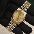 Rolex Datejust 31 ref. 68273 from 1988 in two-tone stainless steel and yellow gold with a factory champagne diamond dial, 31mm case, Jubilee bracelet, sapphire crystal, and automatic movement. Provided in very good condition with a Rolex pouch. Detailed product photos showing the champagne diamond dial, fluted bezel, case, bracelet, clasp, and finishing, offered by Klocksalongen with a 12-month functional warranty.