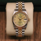 Rolex Datejust 31 ref. 68273 from 1988 in two-tone stainless steel and yellow gold with a factory champagne diamond dial, 31mm case, Jubilee bracelet, sapphire crystal, and automatic movement. Provided in very good condition with a Rolex pouch. Detailed product photos showing the champagne diamond dial, fluted bezel, case, bracelet, clasp, and finishing, offered by Klocksalongen with a 12-month functional warranty.