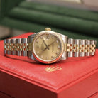 Rolex Datejust 31 ref. 68273 from 1989 in two-tone stainless steel and yellow gold with a factory champagne diamond dial, 31mm case, Jubilee bracelet, sapphire crystal, and automatic movement. Freshly serviced and polished, in very good condition. Complete full set including original 1989 USA certificate, box, booklets, and tag. Detailed product photos showing the diamond-set dial, fluted bezel, case, bracelet, and clasp, offered by Klocksalongen with a 12-month service warranty.