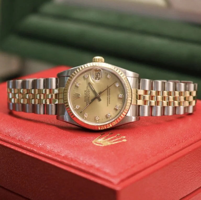 Rolex Datejust 31 ref. 68273 from 1989 in two-tone stainless steel and yellow gold with a factory champagne diamond dial, 31mm case, Jubilee bracelet, sapphire crystal, and automatic movement. Freshly serviced and polished, in very good condition. Complete full set including original 1989 USA certificate, box, booklets, and tag. Detailed product photos showing the diamond-set dial, fluted bezel, case, bracelet, and clasp, offered by Klocksalongen with a 12-month service warranty.