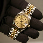 Rolex Datejust 31 ref. 68273 from 1990 in two-tone stainless steel and yellow gold with a factory silver diamond dial, 31mm case, Jubilee bracelet, sapphire crystal, and automatic movement. Unpolished example in extremely good condition with original Spain certificate, box, booklets, and tag. Detailed product photos showing the dial, diamond markers, bezel, case, bracelet, and clasp, available from Klocksalongen with a 12-month functional warranty.