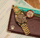 Rolex Datejust 31 ref. 68278 from 1989 in solid yellow gold with a rare factory chocolate/dark grey diamond dial (2020 version), 31mm case, President bracelet, sapphire crystal, and automatic movement. Presented in superb condition and complete with original Italy 1989 certificate, box, booklets, and tag. Detailed photos showing the upgraded dial, diamond markers, gold bezel, case, bracelet, and clasp, offered by Klocksalongen with a 12-month functional warranty.