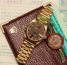 Rolex Datejust 31 ref. 68278 from 1989 in solid yellow gold with a rare factory chocolate/dark grey diamond dial (2020 version), 31mm case, President bracelet, sapphire crystal, and automatic movement. Presented in superb condition and complete with original Italy 1989 certificate, box, booklets, and tag. Detailed photos showing the upgraded dial, diamond markers, gold bezel, case, bracelet, and clasp, offered by Klocksalongen with a 12-month functional warranty.