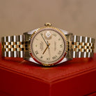 Rolex Datejust 36 ref. 16233 from 2003 in two-tone steel and yellow gold with a champagne Roman numeral dial, 36mm case, Jubilee bracelet, sapphire crystal, and automatic movement. Detailed product photos showing the fluted yellow-gold bezel, Roman hour markers, bracelet links, clasp, and overall condition. Includes original Hong Kong 2003 certificate, box, and tag, offered by Klocksalongen with a 12-month functional warranty.