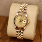 Rolex Lady-Datejust 26 ref. 69173 from 1986 in two-tone stainless steel and yellow gold with a champagne dial, 26mm case, Jubilee bracelet, sapphire crystal, and automatic movement. Recently polished and presented in good condition with Klocksalongen authenticity certificate and packaging. Detailed photos show the champagne dial, gold fluted bezel, case, bracelet, and clasp, offered with a 12-month functional warranty.